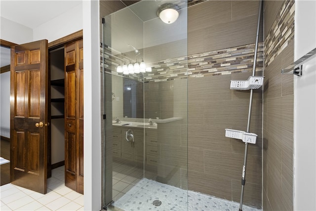 bathroom featuring tile patterned flooring and a shower with shower door