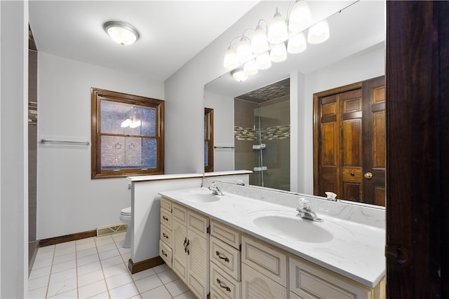 bathroom with tile patterned flooring, vanity, toilet, and a shower with shower door