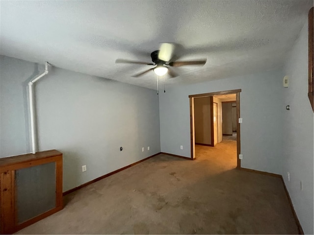 interior space with ceiling fan, light colored carpet, and a textured ceiling