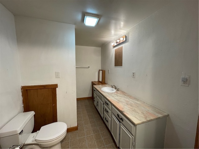 bathroom with tile patterned flooring, vanity, and toilet