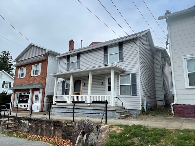 view of front property featuring covered porch