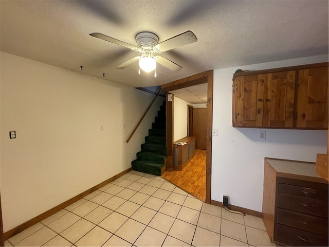 interior space featuring ceiling fan, light hardwood / wood-style flooring, and a textured ceiling