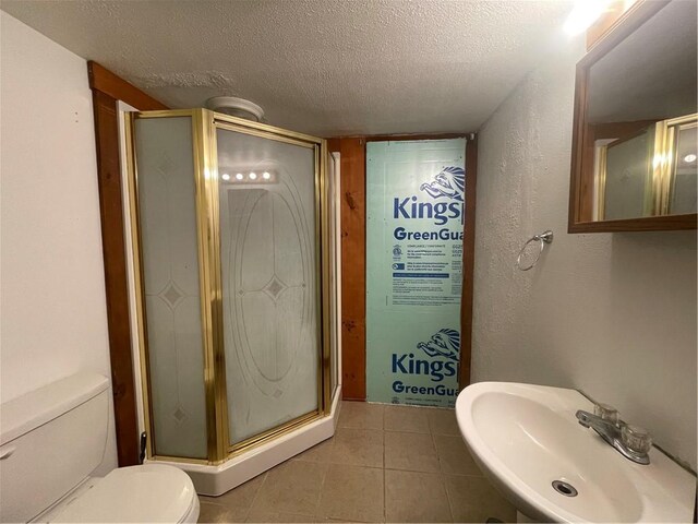 306 E Main St, Ligonier Boro, PA 15658 - bathroom with a sink, a textured ceiling, toilet, a shower stall, and tile patterned floors