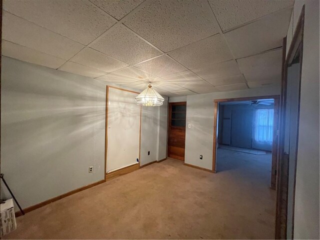 306 E Main St, Ligonier Boro, PA 15658 - spare room with baseboards, light colored carpet, a drop ceiling, and a chandelier
