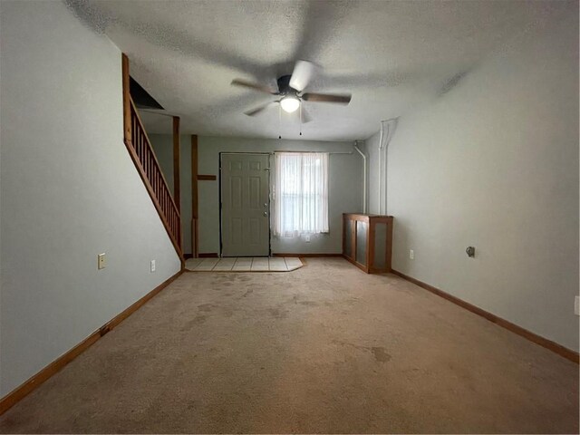 306 E Main St, Ligonier Boro, PA 15658 - interior space with a ceiling fan, light colored carpet, a textured ceiling, baseboards, and stairs