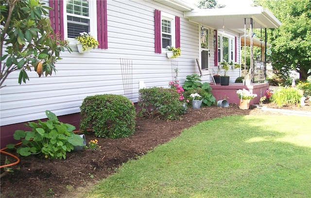 view of home's exterior with a lawn