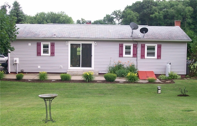 rear view of house with a yard