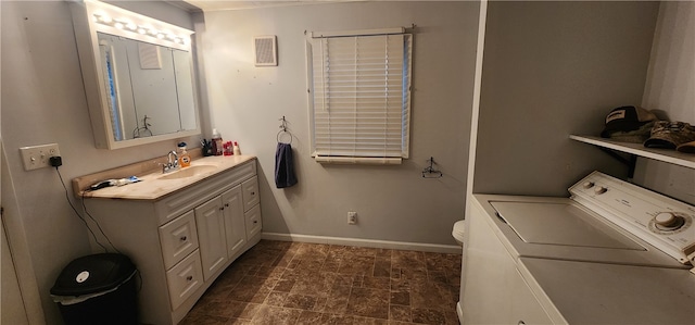 bathroom featuring washer / dryer, vanity, and toilet