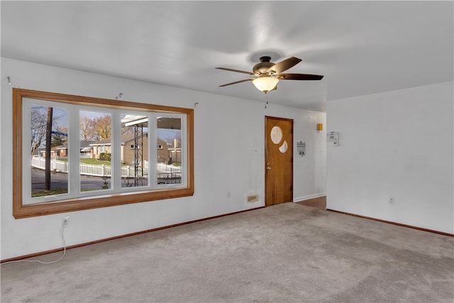 unfurnished room with carpet floors and ceiling fan