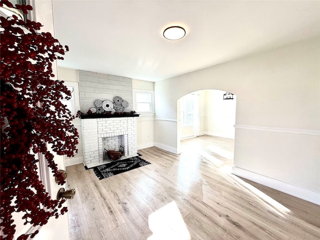 unfurnished living room featuring a fireplace and light wood-type flooring