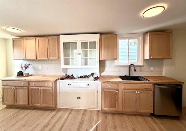 kitchen featuring dishwasher, sink, wood counters, light hardwood / wood-style floors, and decorative backsplash