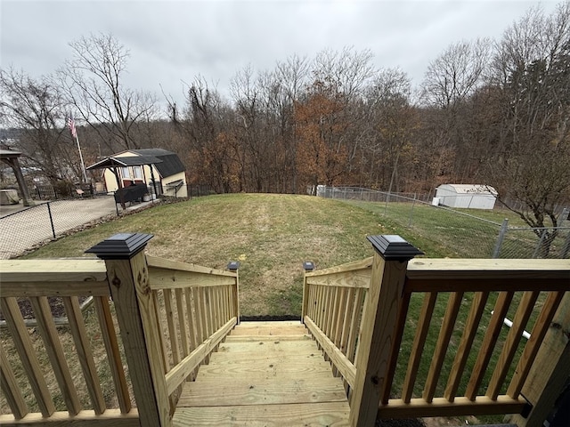 view of yard with a gazebo, a deck, and a storage shed