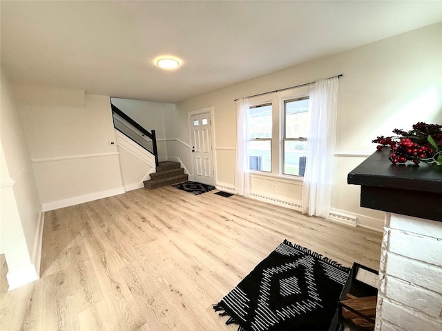 entrance foyer featuring light hardwood / wood-style floors and a baseboard heating unit