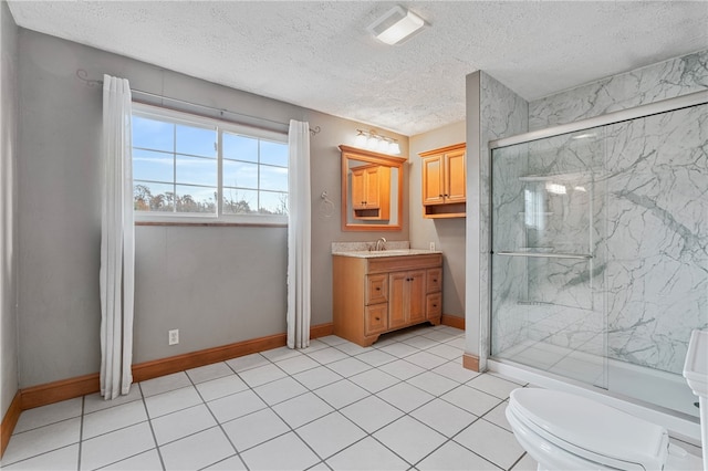 bathroom featuring vanity, an enclosed shower, a textured ceiling, and toilet