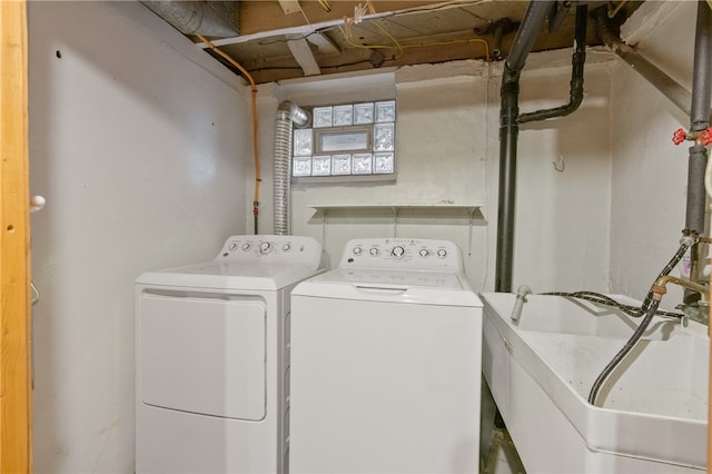 laundry room with washing machine and dryer and sink