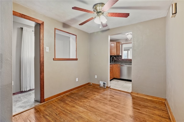 interior space featuring ceiling fan, light hardwood / wood-style floors, and sink