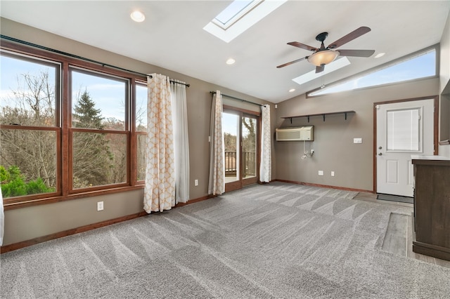 unfurnished living room featuring light carpet, an AC wall unit, ceiling fan, and vaulted ceiling with skylight