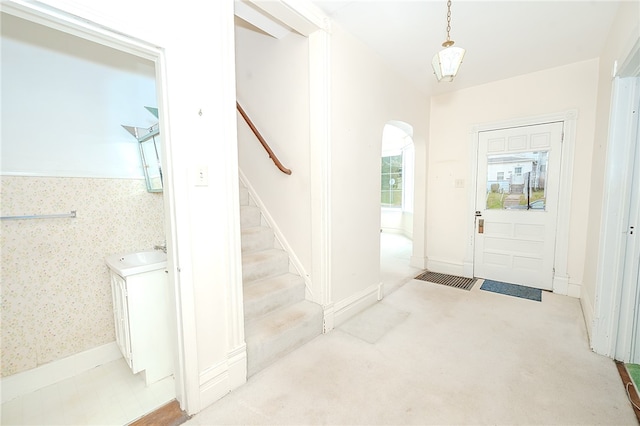 entryway featuring light carpet