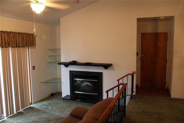 living room with ceiling fan and carpet