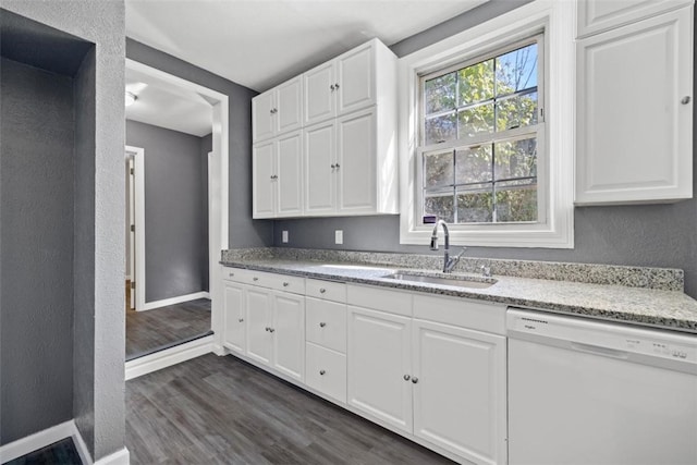 kitchen featuring dishwasher, sink, dark hardwood / wood-style floors, light stone countertops, and white cabinetry