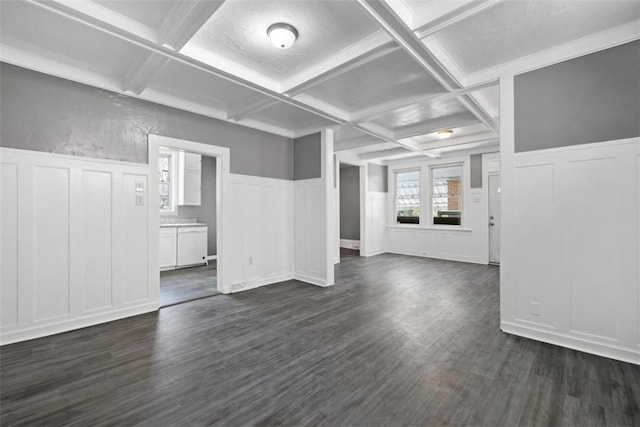 unfurnished living room featuring beamed ceiling, dark hardwood / wood-style flooring, and coffered ceiling