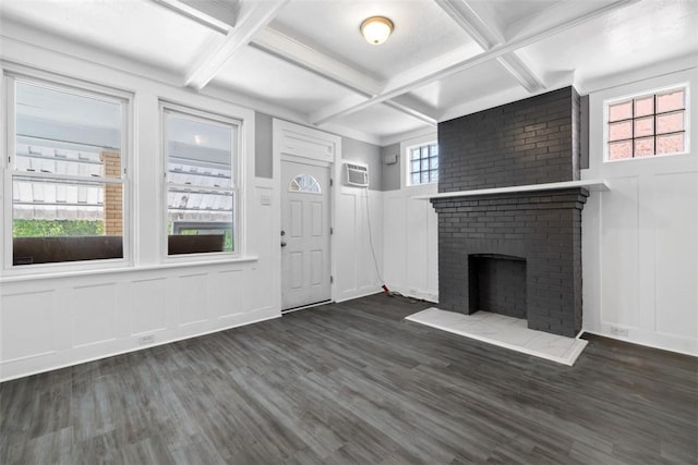 unfurnished living room featuring dark hardwood / wood-style flooring, a brick fireplace, a wealth of natural light, and coffered ceiling