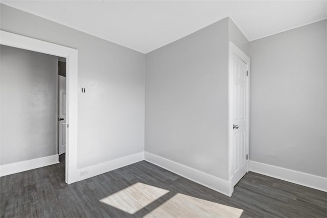 empty room with dark hardwood / wood-style floors