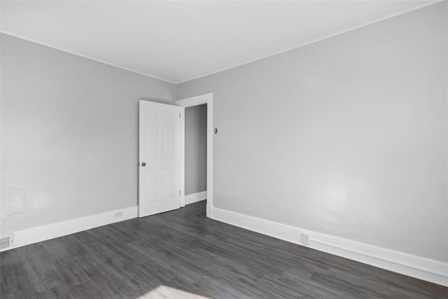 spare room featuring dark hardwood / wood-style floors