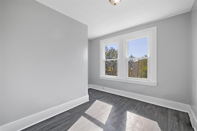 empty room with dark wood-type flooring