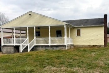 rear view of property with a lawn and covered porch