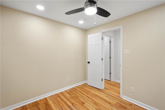 empty room featuring ceiling fan and light hardwood / wood-style flooring