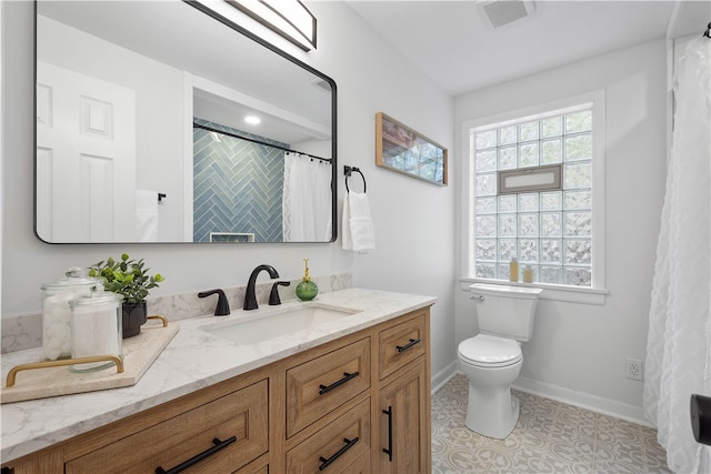 bathroom with tile patterned floors, vanity, and toilet