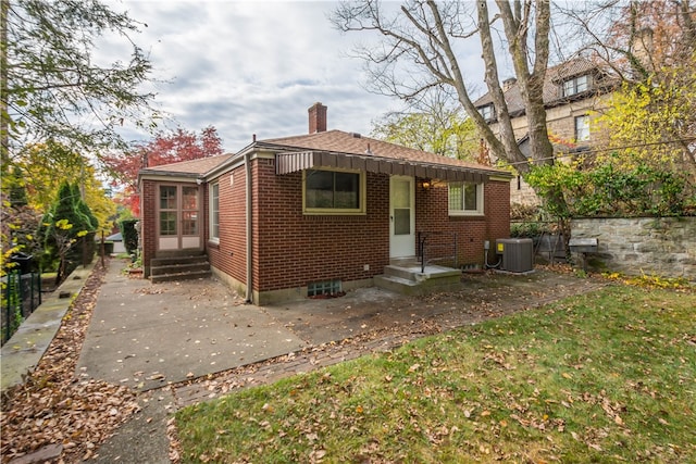 back of property featuring central AC unit