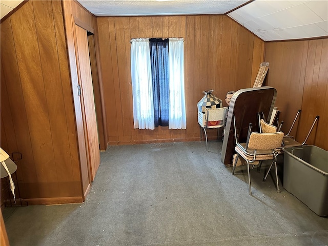 living area with carpet floors, vaulted ceiling, and wooden walls