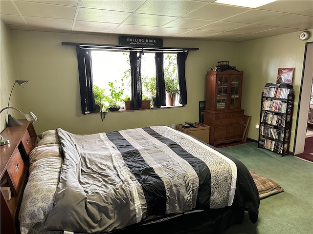 bedroom featuring a paneled ceiling and carpet floors