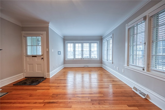 foyer entrance featuring light hardwood / wood-style flooring and ornamental molding