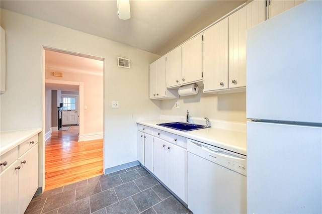 kitchen featuring dark hardwood / wood-style flooring, white appliances, white cabinetry, and sink