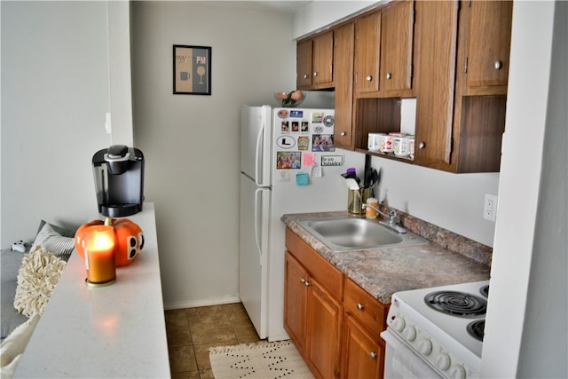 kitchen featuring white appliances, sink, and light tile patterned floors