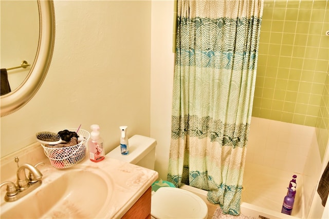 bathroom with vanity, curtained shower, and toilet