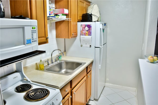 kitchen with backsplash, white appliances, sink, and light tile patterned floors