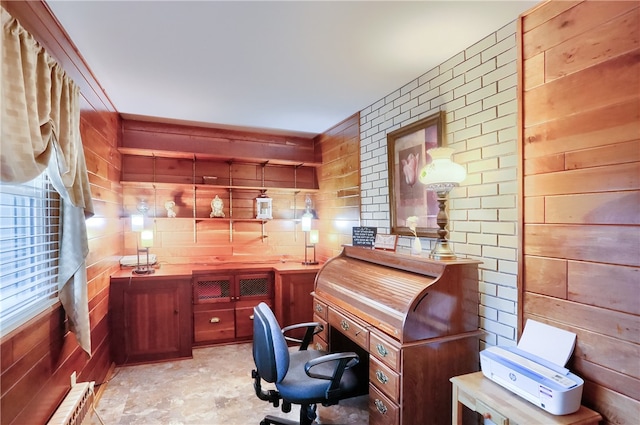 office area featuring radiator and wooden walls