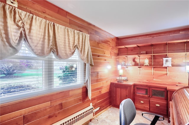 home office featuring wooden walls and a healthy amount of sunlight