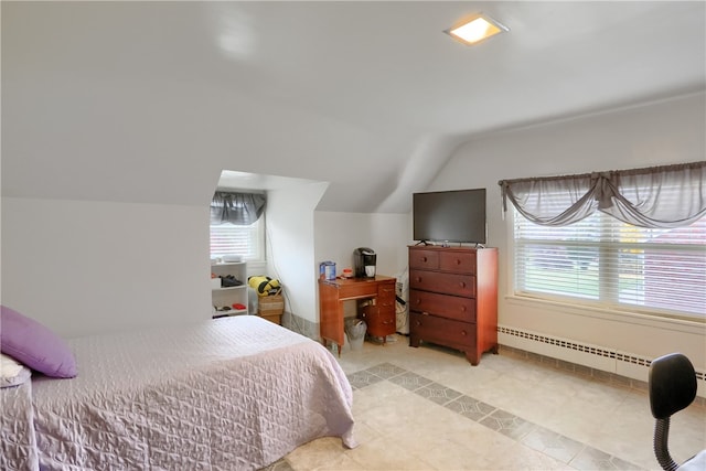 bedroom featuring baseboard heating, multiple windows, and lofted ceiling