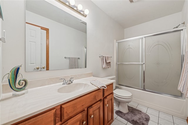 full bathroom featuring tile patterned floors, vanity, bath / shower combo with glass door, and toilet