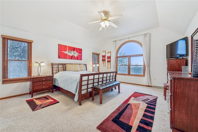 bedroom with ceiling fan, light carpet, and vaulted ceiling