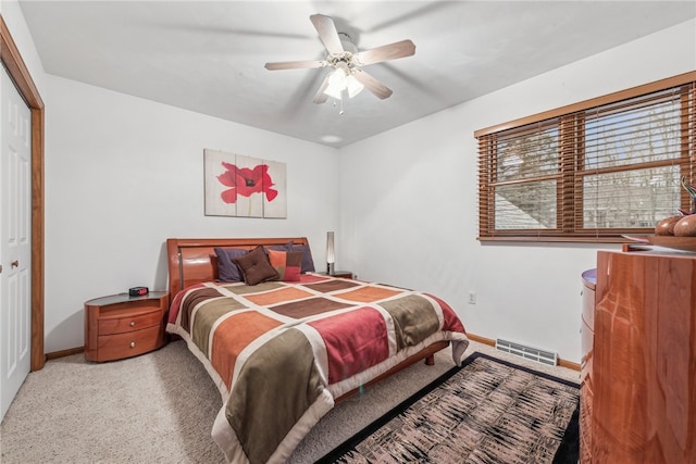 carpeted bedroom featuring ceiling fan and a closet