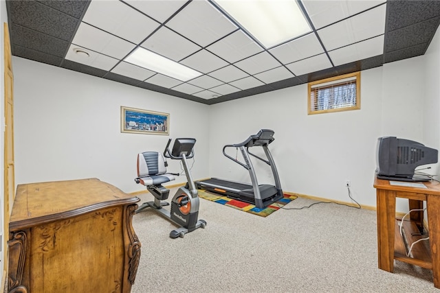 workout room featuring carpet and a paneled ceiling