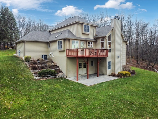 back of property featuring central AC, a deck, a patio area, and a lawn