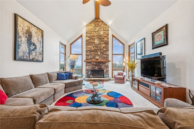 living room featuring beam ceiling, a wealth of natural light, a fireplace, and carpet floors