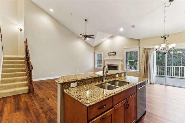 kitchen with dishwasher, sink, dark hardwood / wood-style floors, an island with sink, and decorative light fixtures